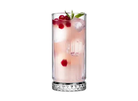 Fluted highball glass with a pink drink and berries
