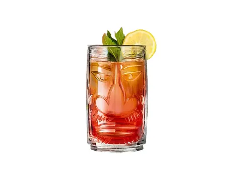 Tiki glass with an amber drink, lemon and mint